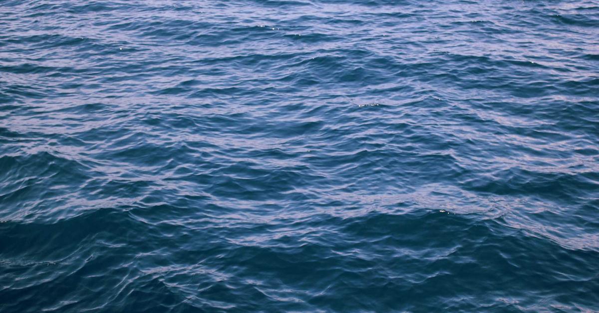 Blue ocean surface with gentle, rippling waves catching sunlight